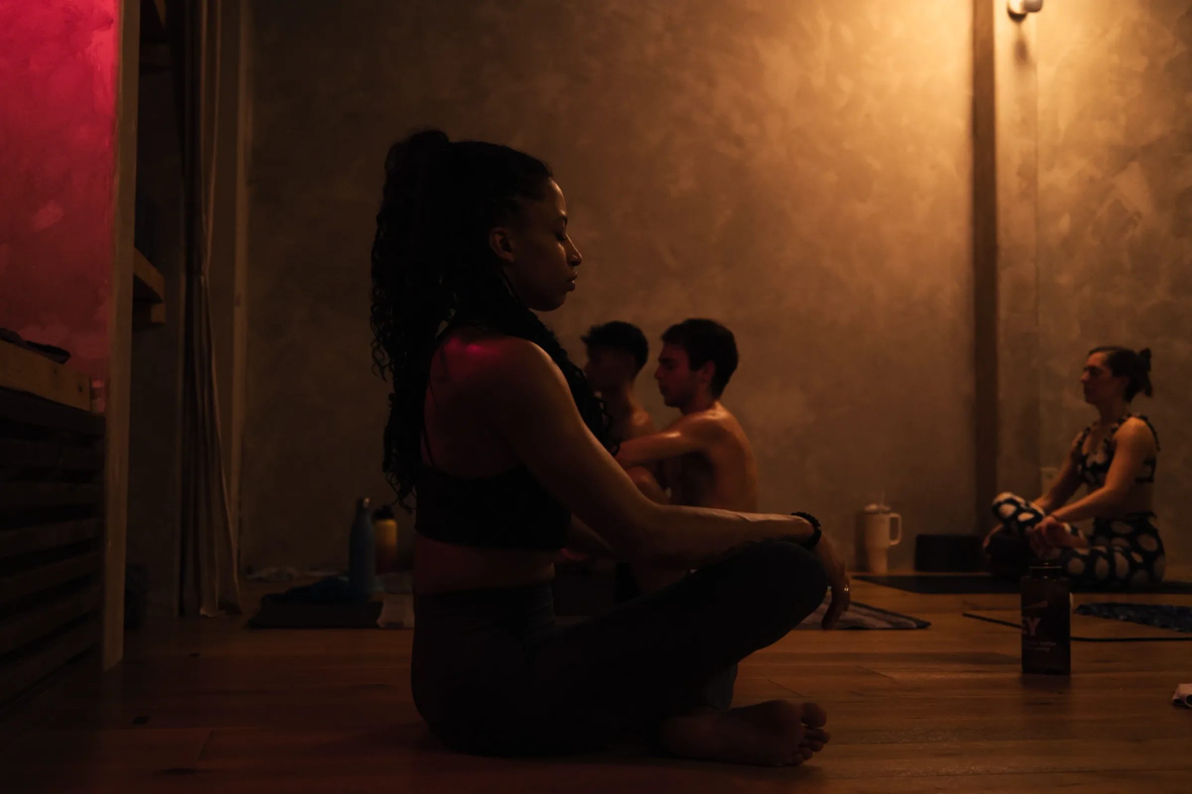 Students settling into a heated yoga class at REWILD