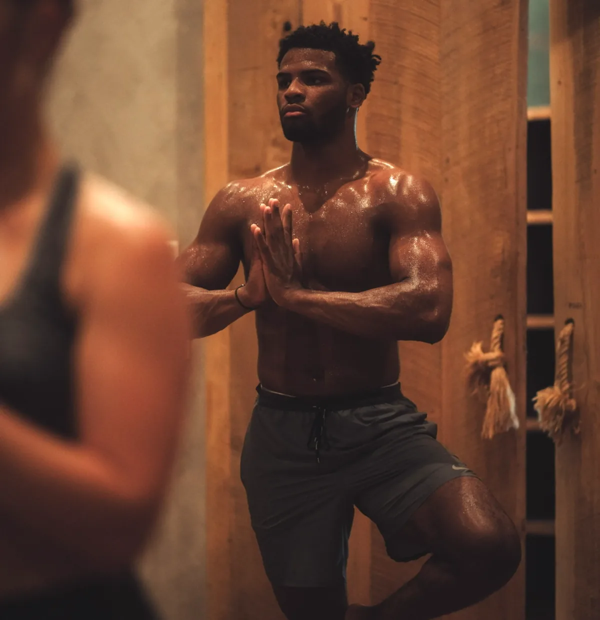 A student pausing between movements in a heated REWILD class