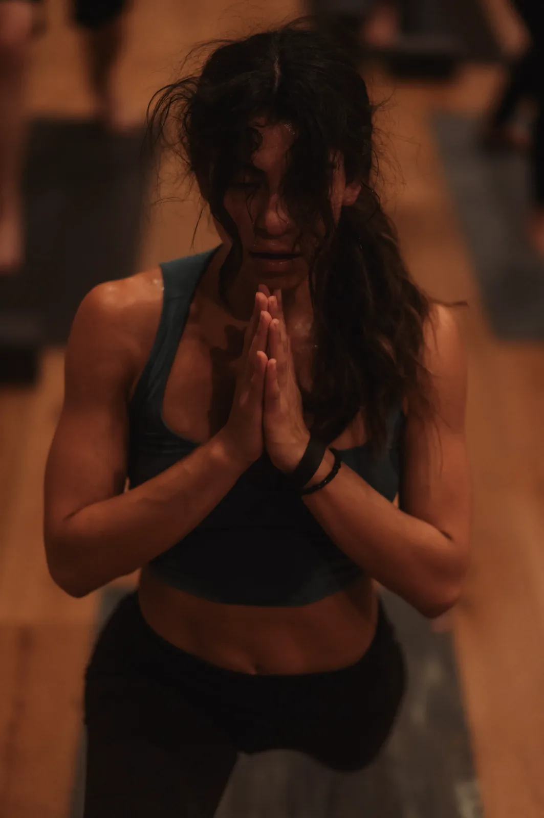 A student centering with hands at heart during class