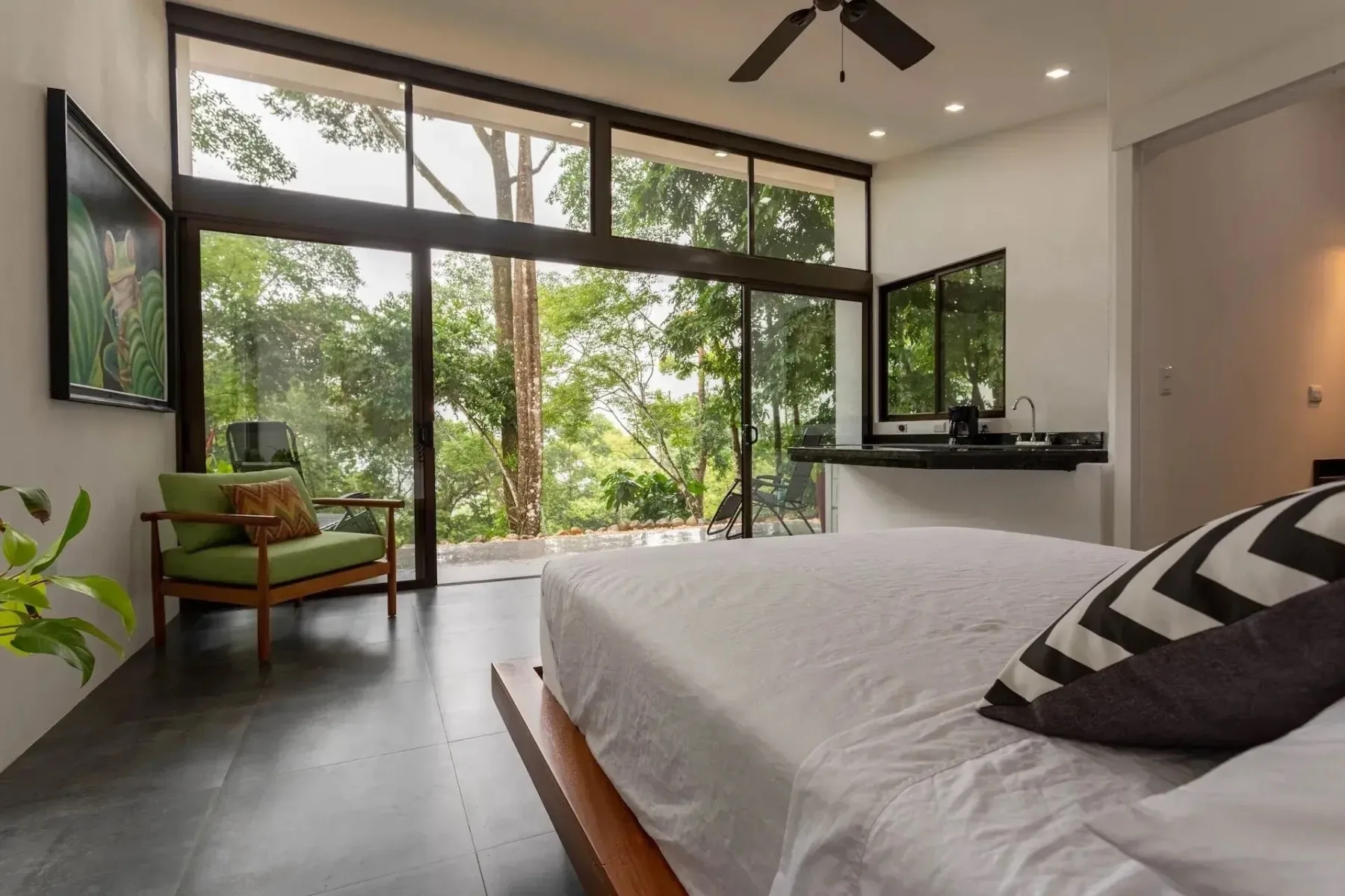 Bright private villa bedroom looking into the jungle