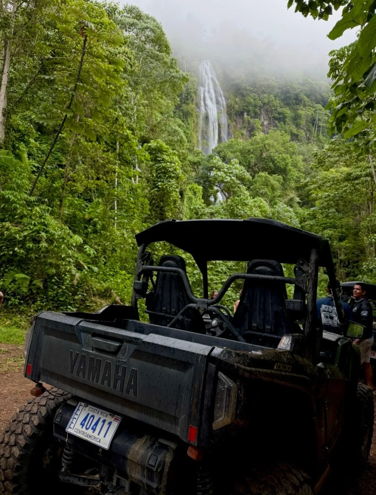 ATV parked beside a jungle waterfall