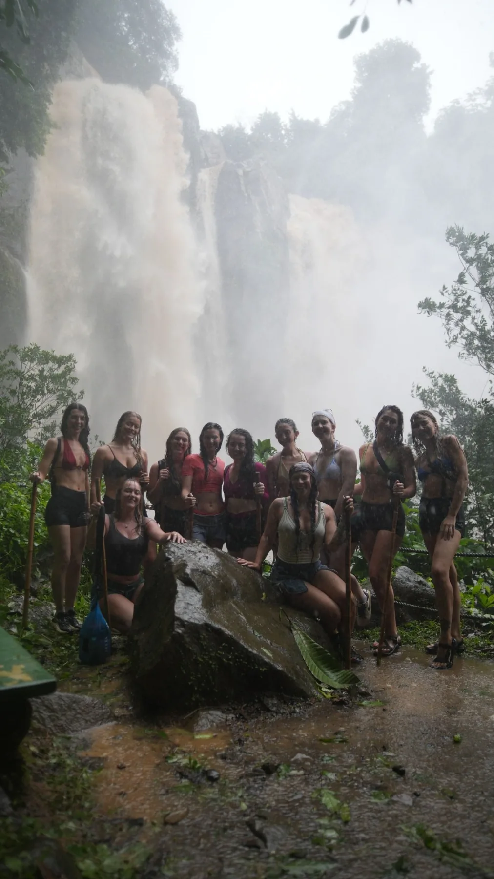 Retreat group gathered beneath a waterfall