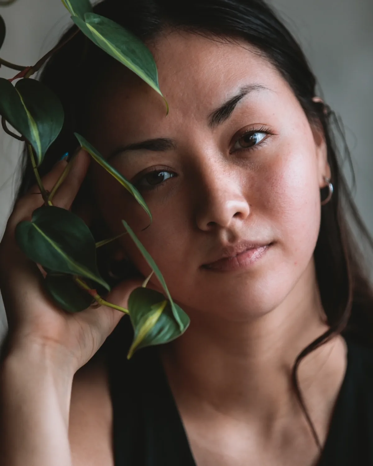 A REWILD community member framed by living leaves